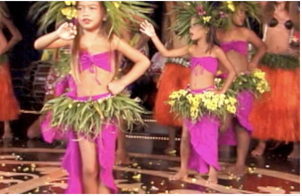 An image of Tahitian toddlers dancing in front of public