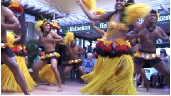 An image of male and female Tahitian dancers perform.