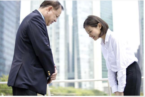 An image of 2 Japanese people bowing to show respect.