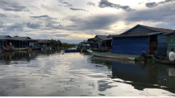 An image of a community of houseboats in the middle of Tonle Sap Lake in Cambodia