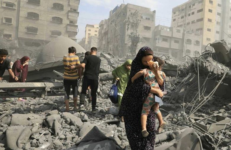 A Palestinian woman holds child after Israeli forces attacked and bombed a building in the Gaza Strip.